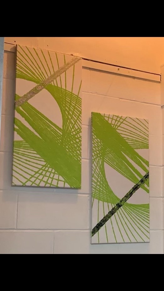 Green abstract brushstroke paintings on white wall