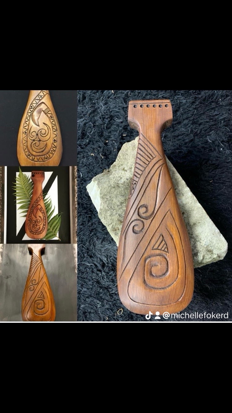 Carved wooden taonga - hei tiki and koru paddles